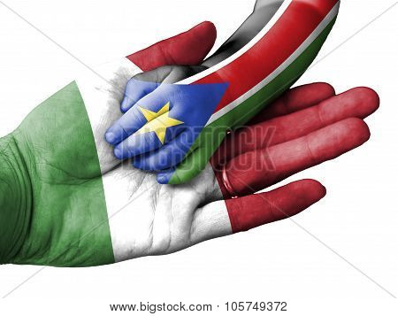 Adult Man Holding A Baby Hand With Italy And South Sudan Flags Overlaid. Isolated On White