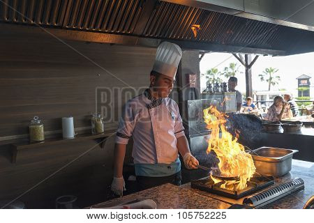 ISTANBUL TURKEY SEPT 28 2014 Chef in restaurant kitchen doing flambe on food