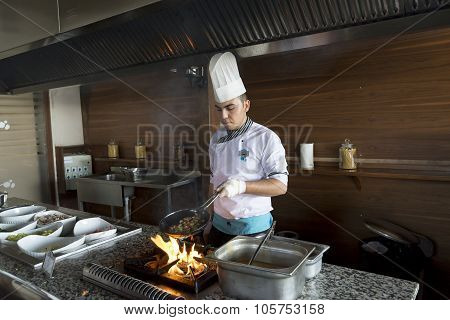 ISTANBUL TURKEY SEPT 28 2014 Chef in restaurant kitchen doing flambe on food