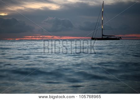 Yacht Floating In Sea Under Amazing Sunset