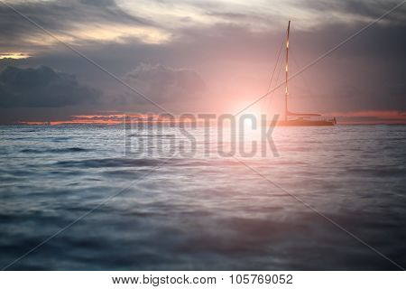 Yacht Floating In Sea Under Amazing Sunset