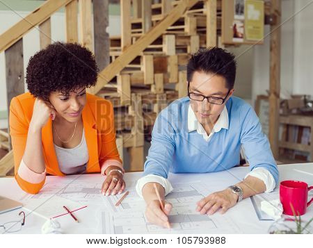 Two desingers working on a project together in office