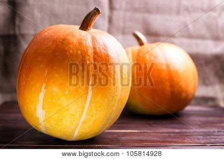 Two Big Pumpkins On A Table
