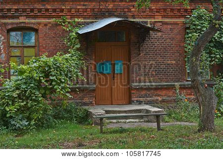 Old Ragged Door Of An  Brik  House.