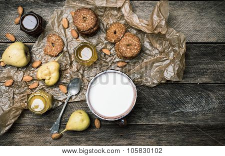 Tasty Pears Almonds Cookies And Joghurt On Rustic Wood