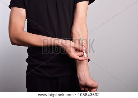 Hand Of The Narcotist Preparing To Inject Drugs