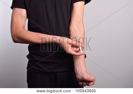Hand Of The Narcotist Preparing To Inject Drugs