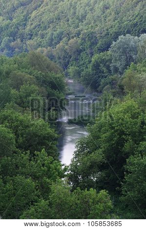 Small River With Dense Trees On The Banks