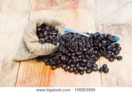 Coffee Beans In Burlap Sack With Spoon.