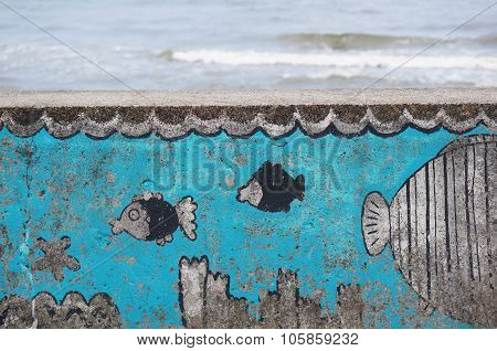 GDYNIA POLAND - JULY 27 2015: Fish drawings on a wall by a beach in the evening