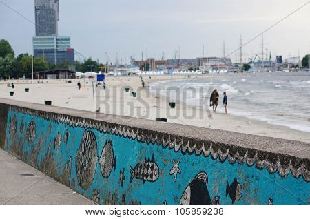 GDYNIA POLAND - JULY 27 2015: Fish drawings on a wall by a beach in the evening