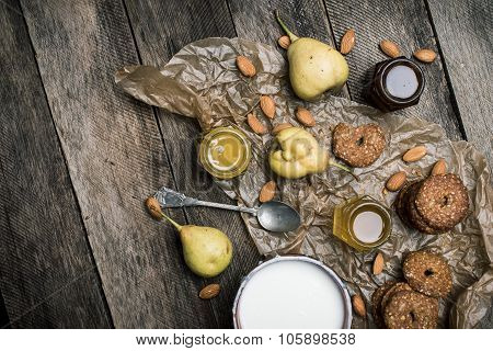 Pears Nuts Cookies And Joghurt On Rustic Wood
