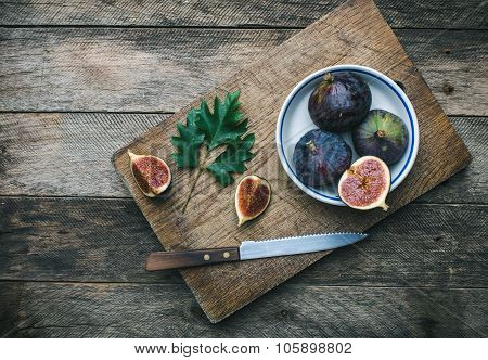 Cut Figs And Knife On Chopping Board In Rustic Style