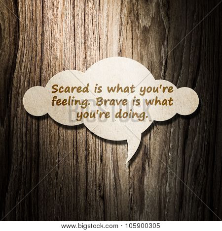 Meaningful Quote On Paper Cloud With Wooden Background