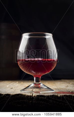 Glass white wine and bunch grapes on background of wooden