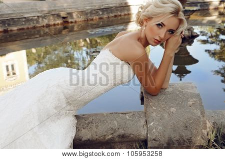Gorgeous Bride With Blond Hair Wears Luxurious Dress And Accessories