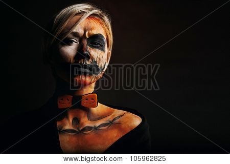 Halloween Portrait Of Body Art Pumpkin Girl With Pumpkin Bowtie On Black Background. Real Greasepain