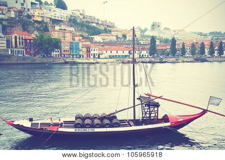 PORTO, PORTUGAL - May 13, 2012: Boat with barrels of port wine on Douro river in Porto. Instagram style filtered image