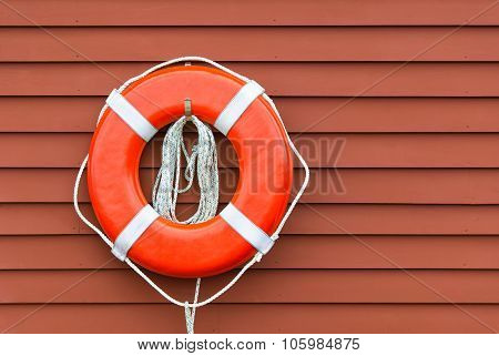 Ring Buoy On Red Wooden Wall, Copy Space