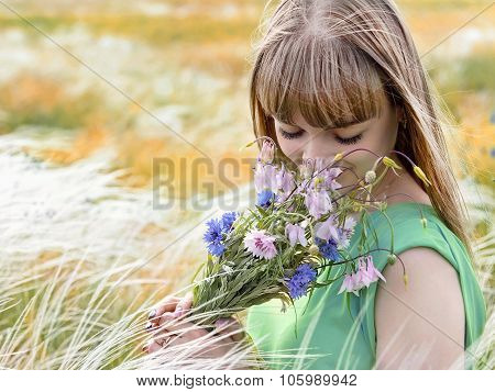 Young Sensual Girl Smelling A Bouquet Of Wildflowers