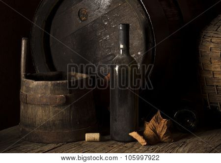 Still life with wine bottles, glasses and oak barrels  vintage