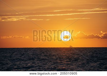 Albania. Golem. Sunset on the Adriatic Sea with the silhouette of the ship on the horizon