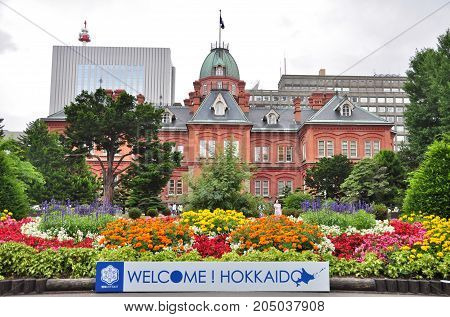 Hokkaido, Japan - July 24, 2013: The Former Hokkaido Government Office with a welcome sign in Sapporo city, Hokkaido, Japan. That Building was first completed in 1888 and known in Red Bricks Building.