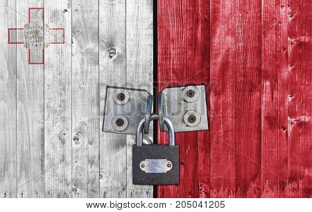 Malta flag on door with padlock close
