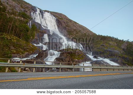 Summer Mountain Langfossen Waterfall On Slope Etne, Norway.