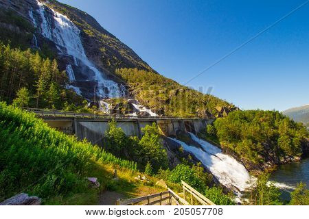 Summer Mountain Langfossen Waterfall On Slope Etne, Norway.