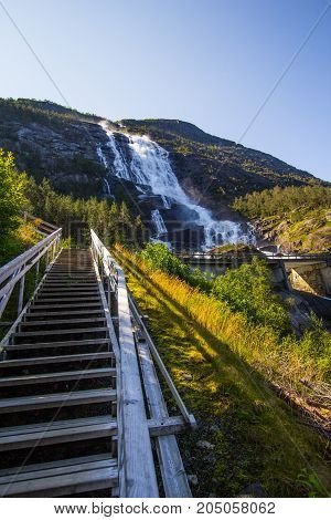 Summer Mountain Langfossen Waterfall On Slope Etne, Norway.