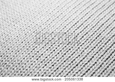 Texture of knitted fabric. Stranded threads. Cloth of warm winter clothes. Blurred.