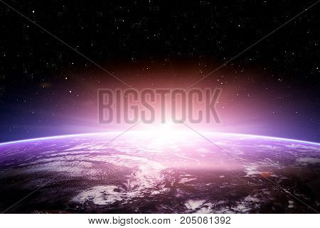 Blue Planet Earth sunrise over cloudy ocean with stars in the sky.