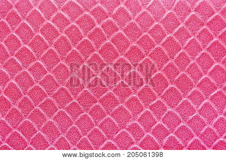 Texture of artificial skin pink color. Pattern of a rhombus. Bright colors.