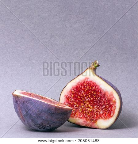 figs cut into two parts. Juicy fruit. Bright colors. Blurred background.