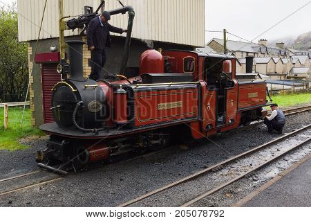 Blaenau Ffestiniog Wales UK - September 4 2017: Narrow gauge steam locomotive David Lloyd George of the Ffestiniog Railway Company having her water tanks filled at the station