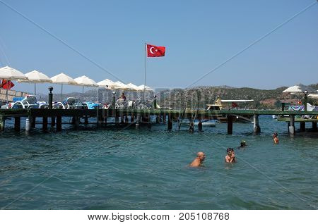 Marmaris, Turkey - August 16, 2017: Family enjoys water during summer holiday near jetty in Marmaris, Turkey