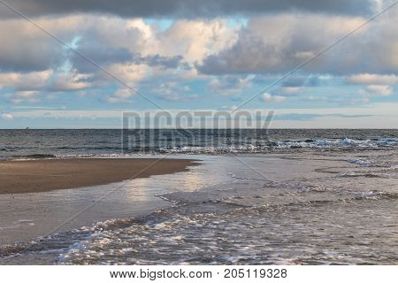 Waves of Skagerrak and Kattegat meeting at Grenen, Skagen, the most northern point of Denmark. Blue sky and white clouds