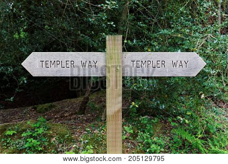 Dartmoor, Devon, UK, May 9, 2017. Editorial photograph of wooden route sign near Bovey Tracey on the edge of Dartmoor, showing the route of the Templer Way, a walking trail that follows an old granite tramway.