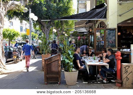 TEL AVIV, ISRAEL - APRIL 1, 2016: People in outdoor cafe on Dizengoff Street in Tel Aviv, Israel.