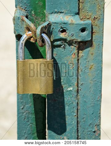 Padlock on the closed metal door outdoor