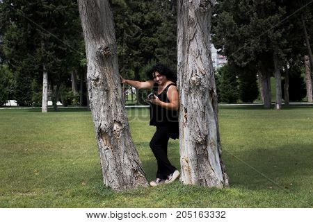 Woman talking on mobile phone in nature on a summer morning