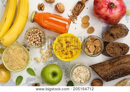 Assortment of products rich of complex carbohydrates. Healthy food on white stone background. Space for text