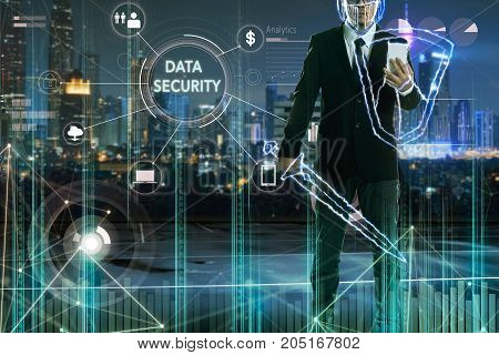 Businessman turned into thunder warriorholding a lightning sword and shield with "DATA SECURITY" word on digital virtual screen.Business security concept .