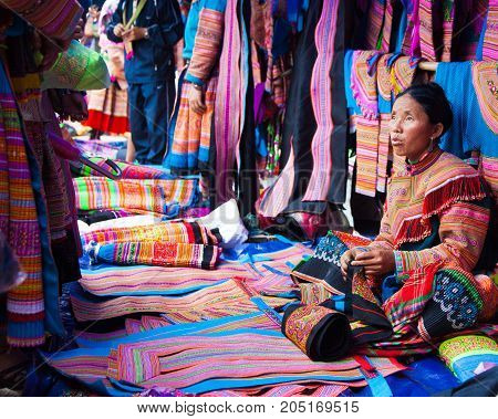 North Vietnamese Woman In Colorful Native Clothing Sells Similar Clothes At Bac Ha Market