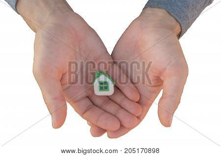 Man's hands hold small plasticine toy house isolated on white background. Buying a house concept.