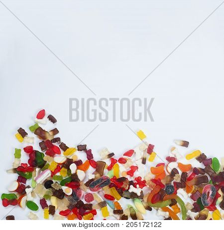 Tasty Mixed colorful sweets jelly Different sorts candy on white background Top view. Copy space.