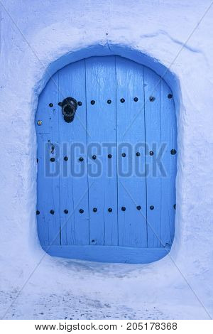 Traditional powder blue painted house facade and door in the historical Medina of Chefchaouen Morocco