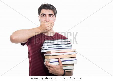 Handsome Student Holding Pile Of Books Covering Mouth