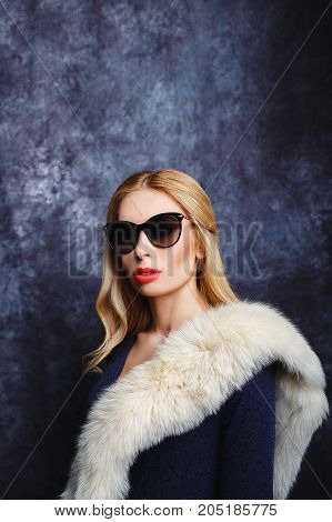 Stylish blonde in arctic fox and sun glasses.
